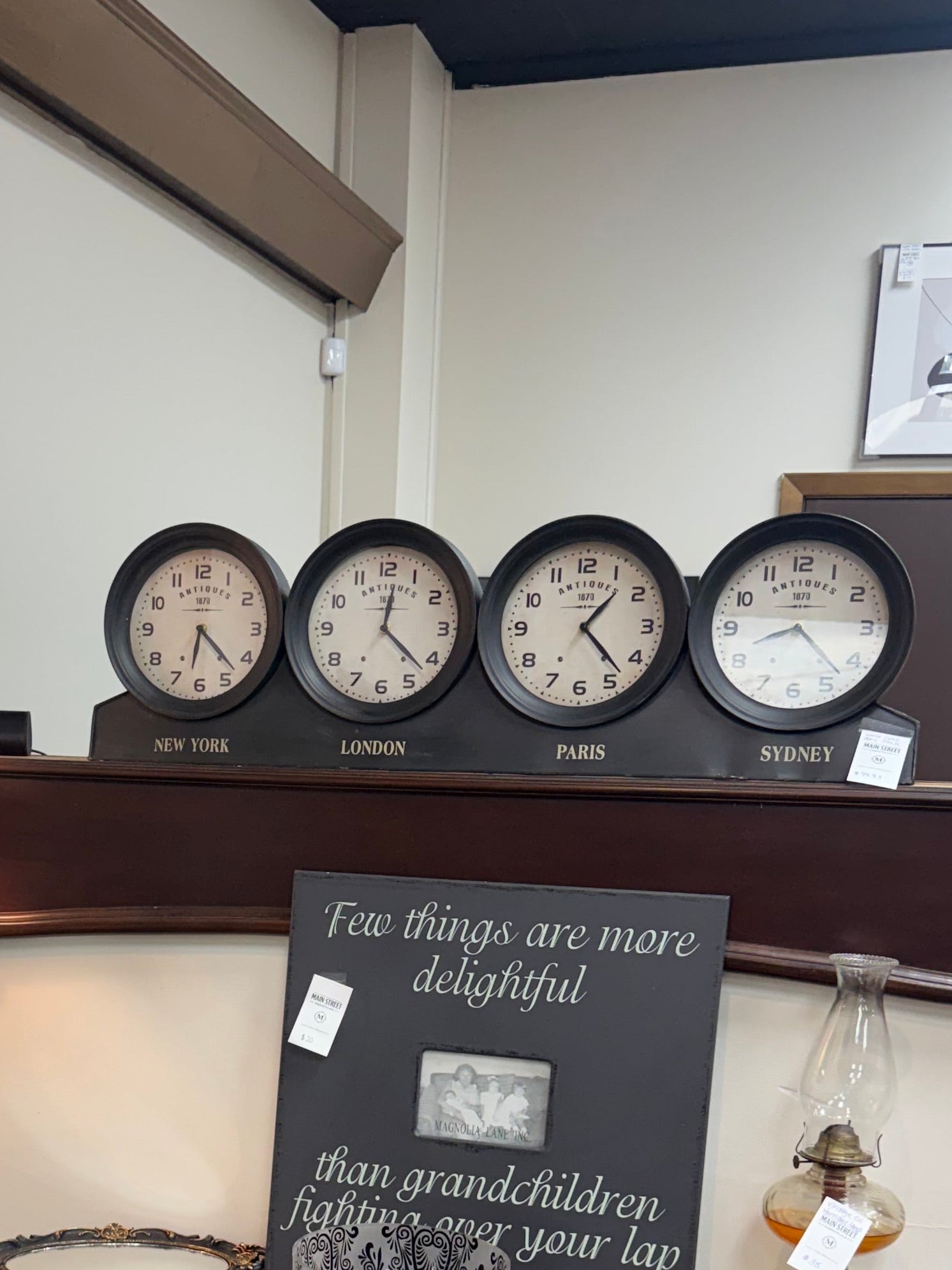 Vintage-style interior with wooden desk, decorative items, and wall clocks.
